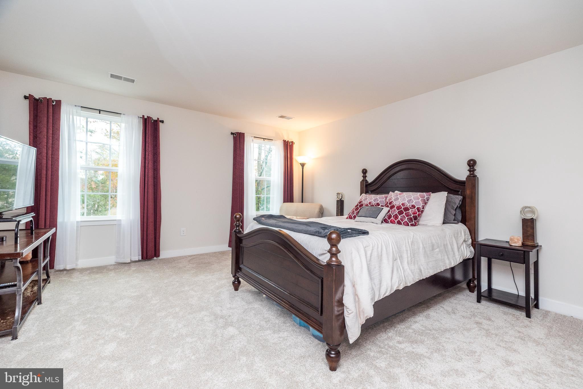 121 Arbor Boulevard Perkasie, PA 18944 - Photo 23 of 39 a bedroom with a bed and a flat tv screen on dresser