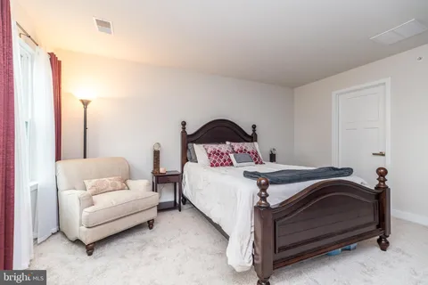 a bedroom with a bed and a couch