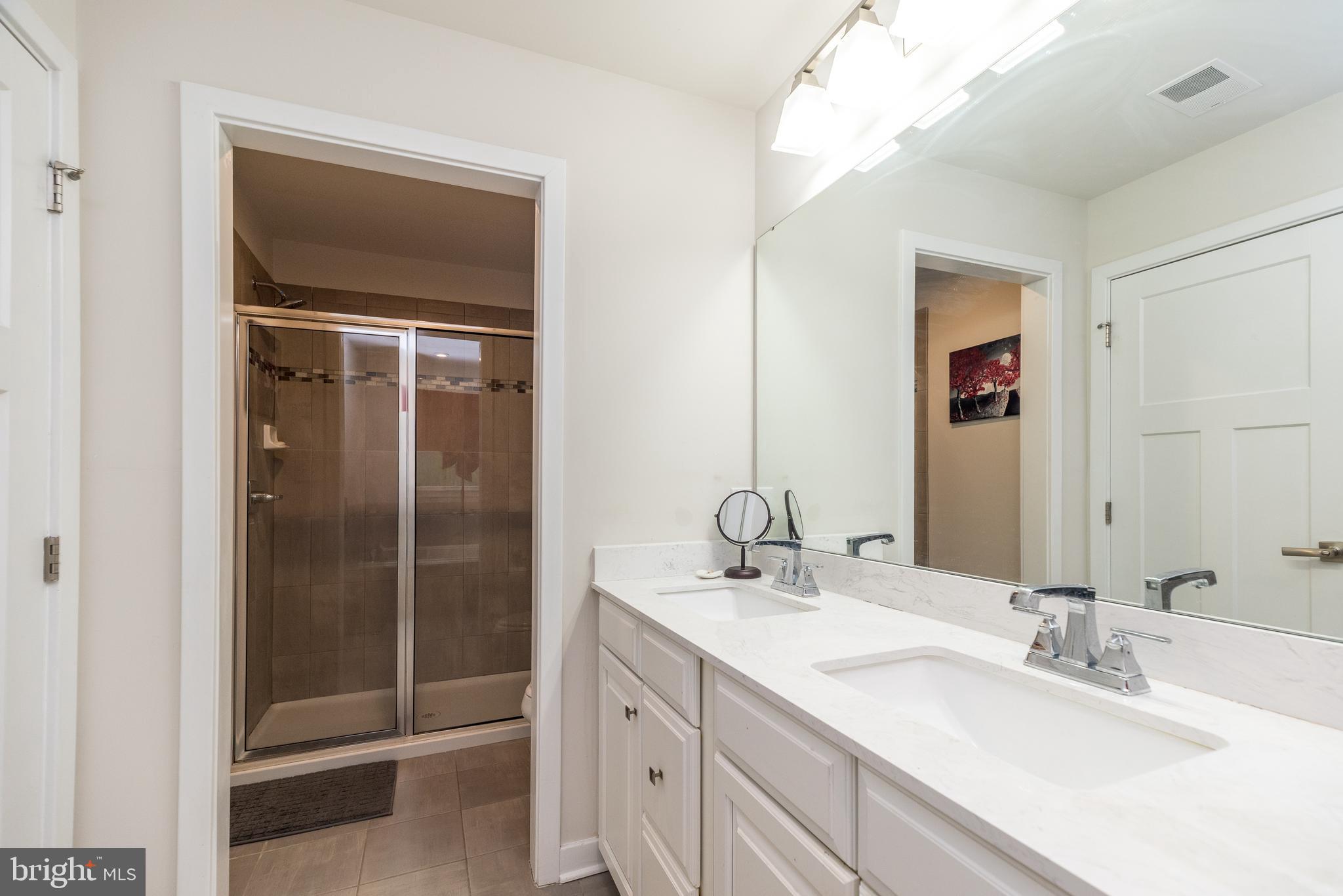 121 Arbor Boulevard Perkasie, PA 18944 - Photo 25 of 39 a bathroom with a double vanity sink and mirror