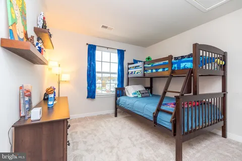 a bedroom with bed and window