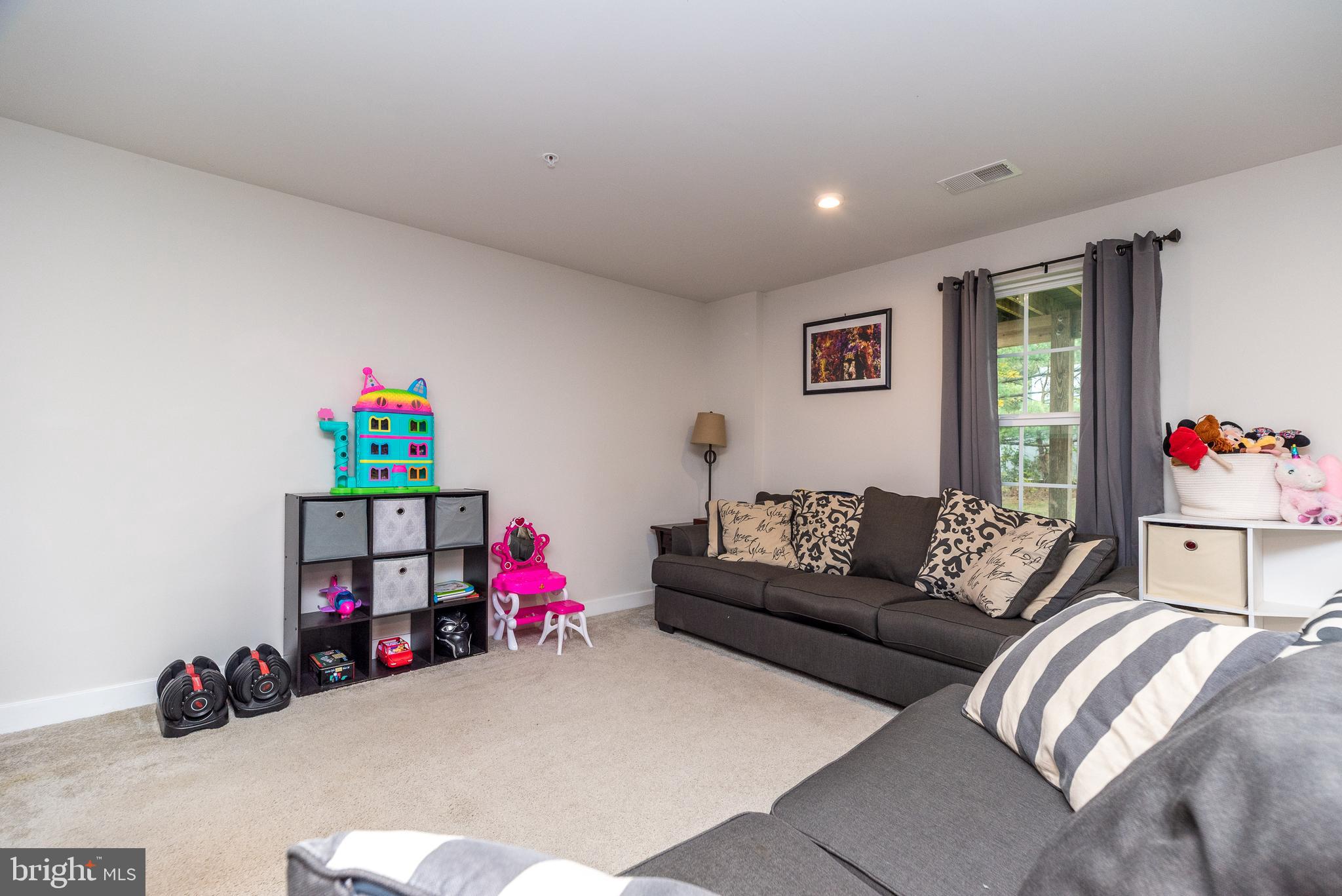 121 Arbor Boulevard Perkasie, PA 18944 - Photo 33 of 39 a living room with furniture and a book shelf