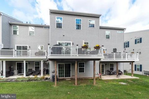a view of a building with a yard and sitting area