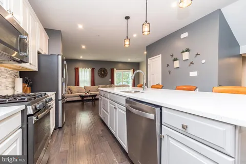 a large kitchen with stainless steel appliances kitchen island a large island in the center