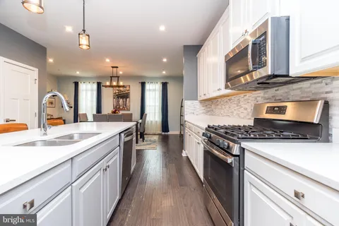 a kitchen with stainless steel appliances granite countertop a stove and a sink