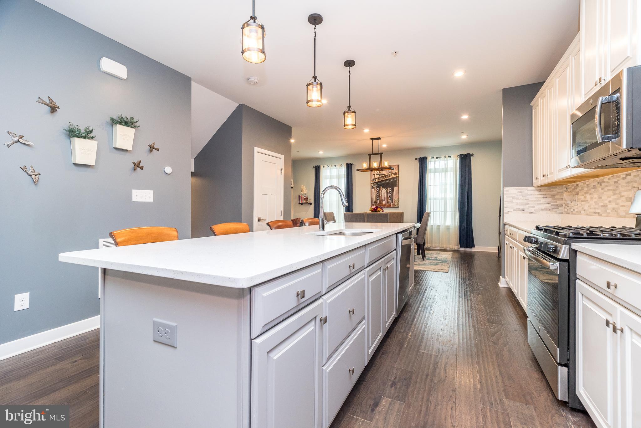 121 Arbor Boulevard Perkasie, PA 18944 - Photo 8 of 39 a large kitchen with stainless steel appliances kitchen island granite countertop a large center island and a stove top oven