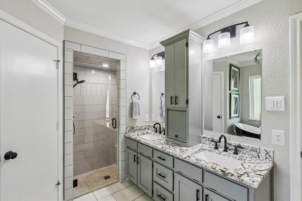 404 Moonlight Lane Keller, TX 76248 - Photo 22 of 40 a bathroom with a shower sink vanity granite and mirror