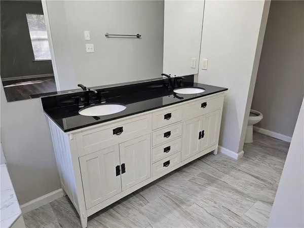 a bathroom with a shower and a sink
