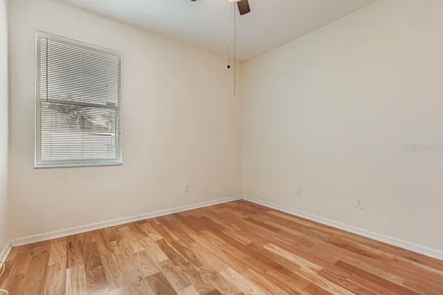 a view of a room with wooden floor and windows