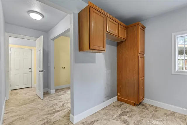 an entryway view with wooden floor and cabinet