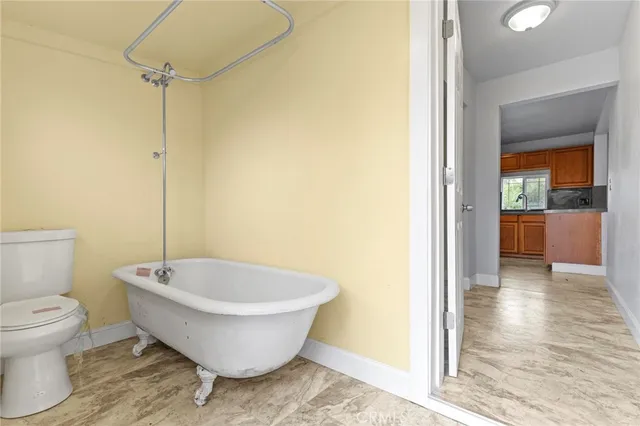 a spacious bathroom with a bathtub and toilet