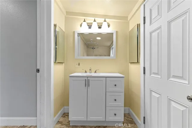 a bathroom with a sink and mirror