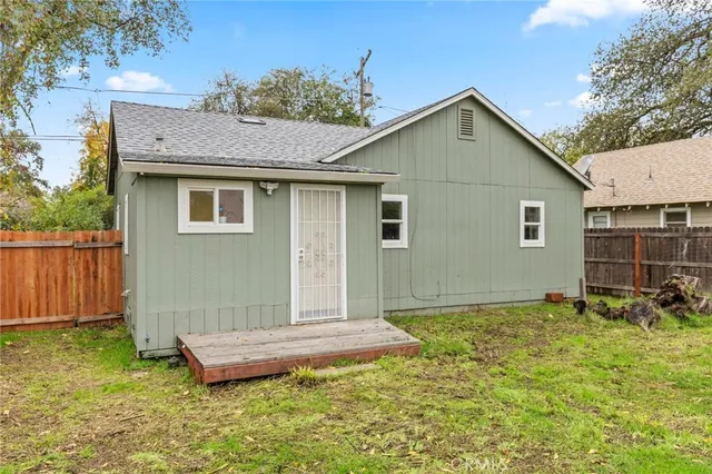 a backyard of a house with yard and outdoor seating