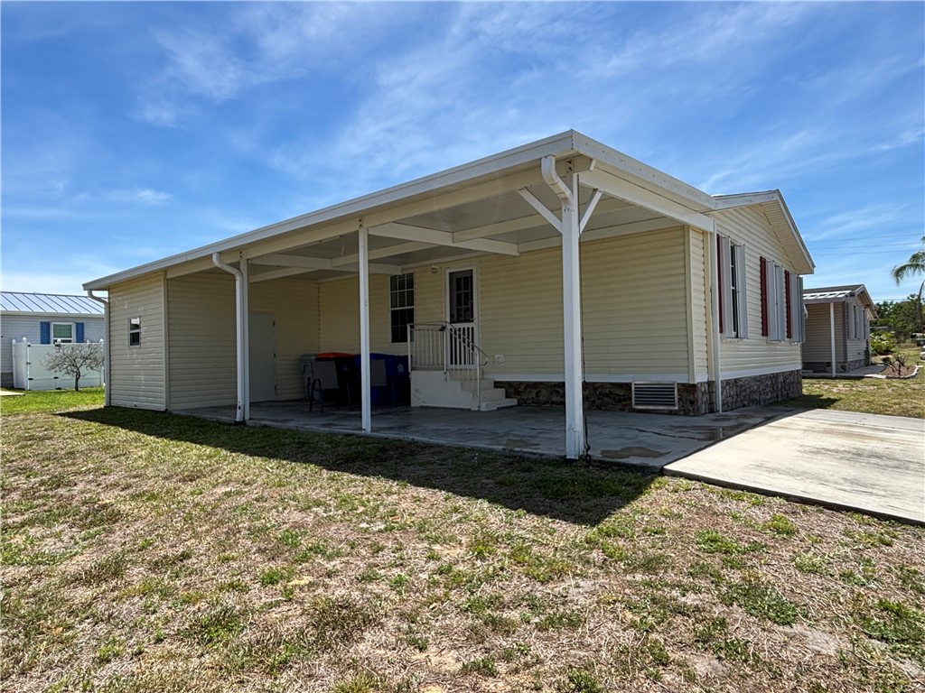 6171 98th Road Sebastian, FL 32958 - Photo 3 of 14 a front view of a house with garden
