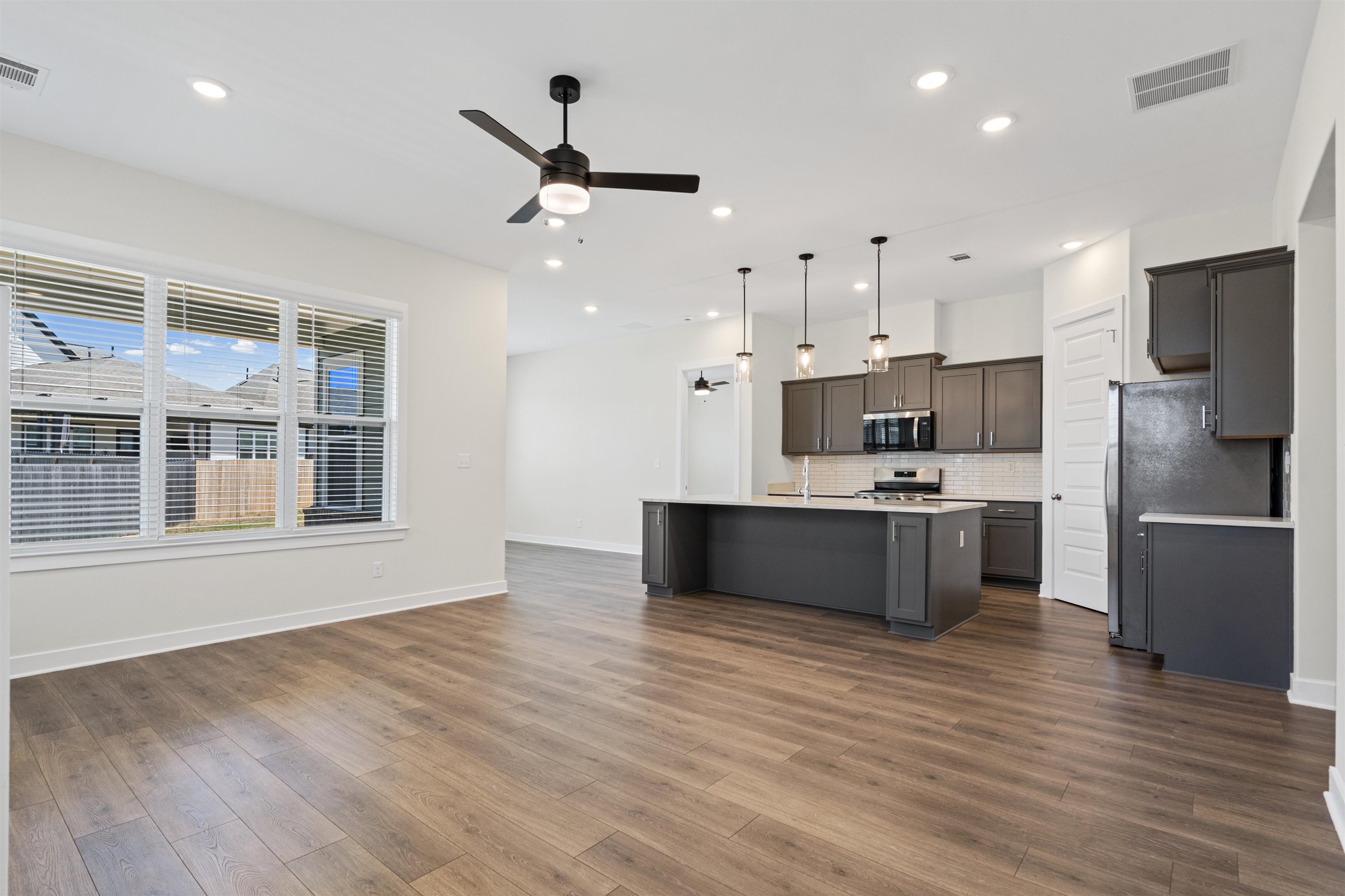 5666 Pleasant Pk Place Arlington, TN 38002 - Photo 13 of 27 Open-concept living area featuring wood-finish flooring, recessed lighting, and a contemporary ceiling fan