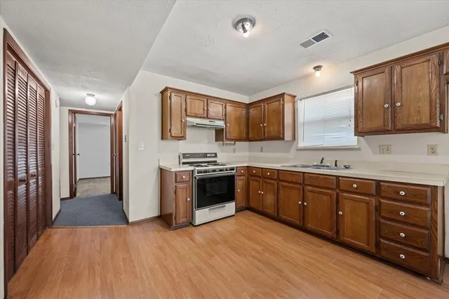 an empty room with windows and chandelier