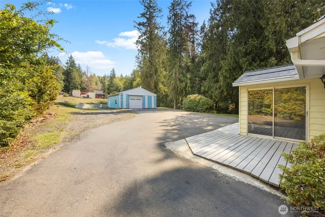 a view of a house with backyard and sitting area