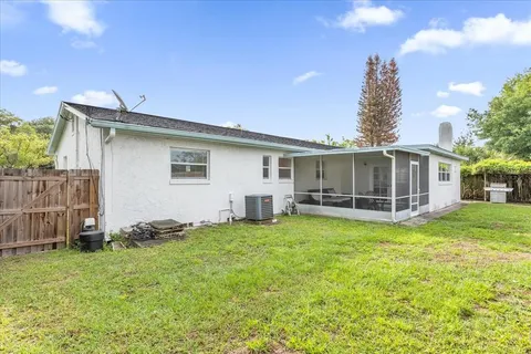 a view of a house with a yard and sitting area