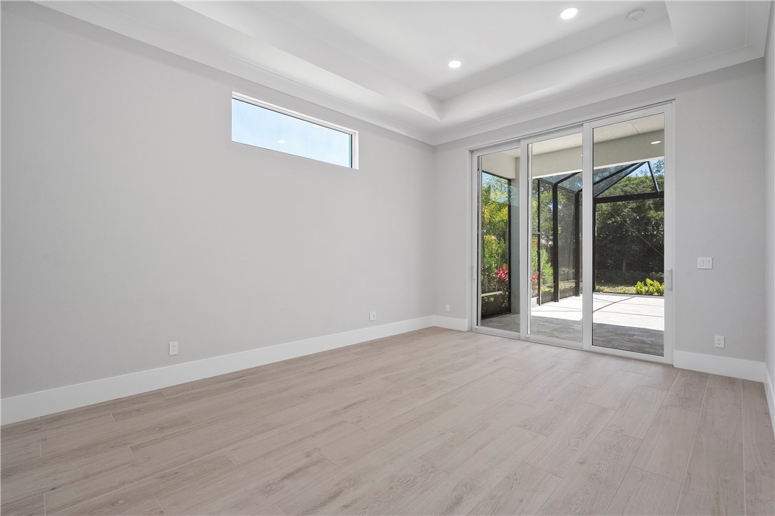 129 Strand Drive Vero Beach, FL 32963 - Photo 12 of 30 a view of an empty room with wooden floor and a window