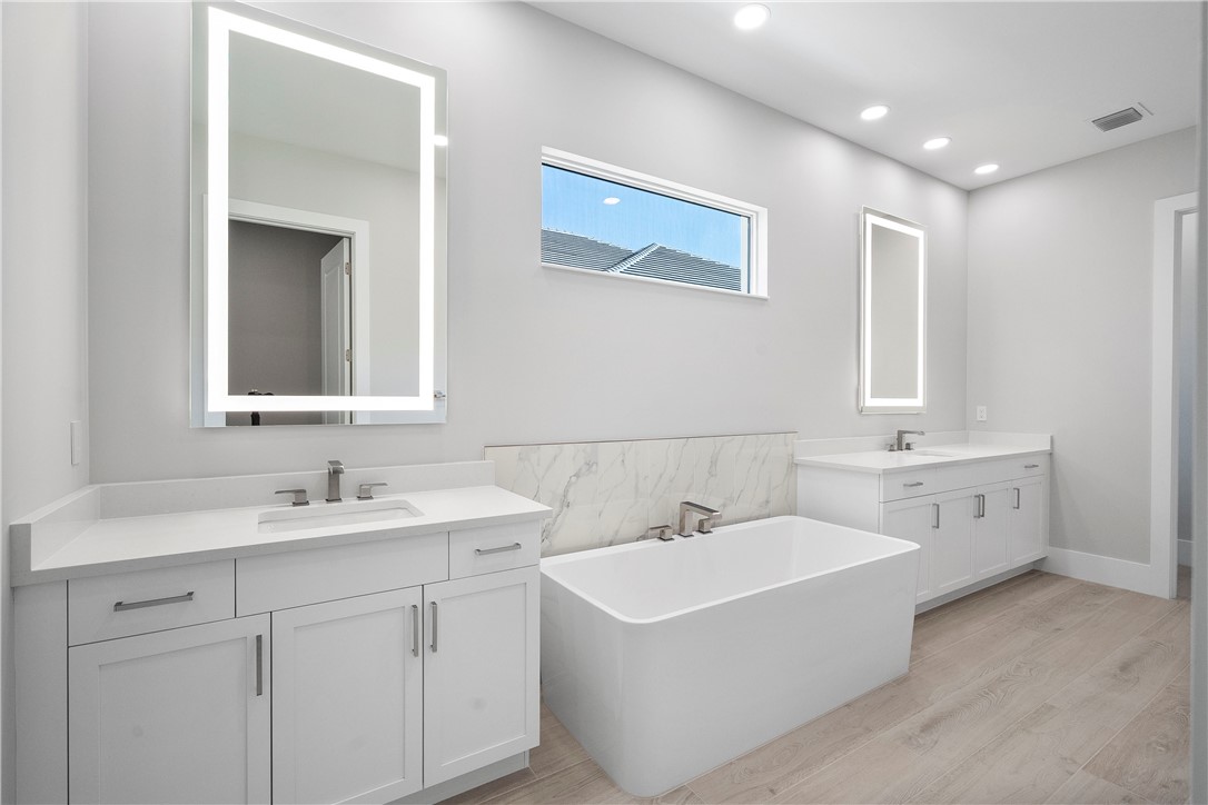 129 Strand Drive Vero Beach, FL 32963 - Photo 13 of 30 a bathroom with 2 sink tub and a mirror