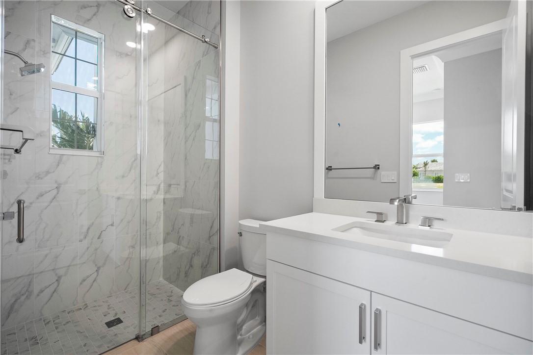 129 Strand Drive Vero Beach, FL 32963 - Photo 15 of 30 a bathroom with a sink toilet and shower