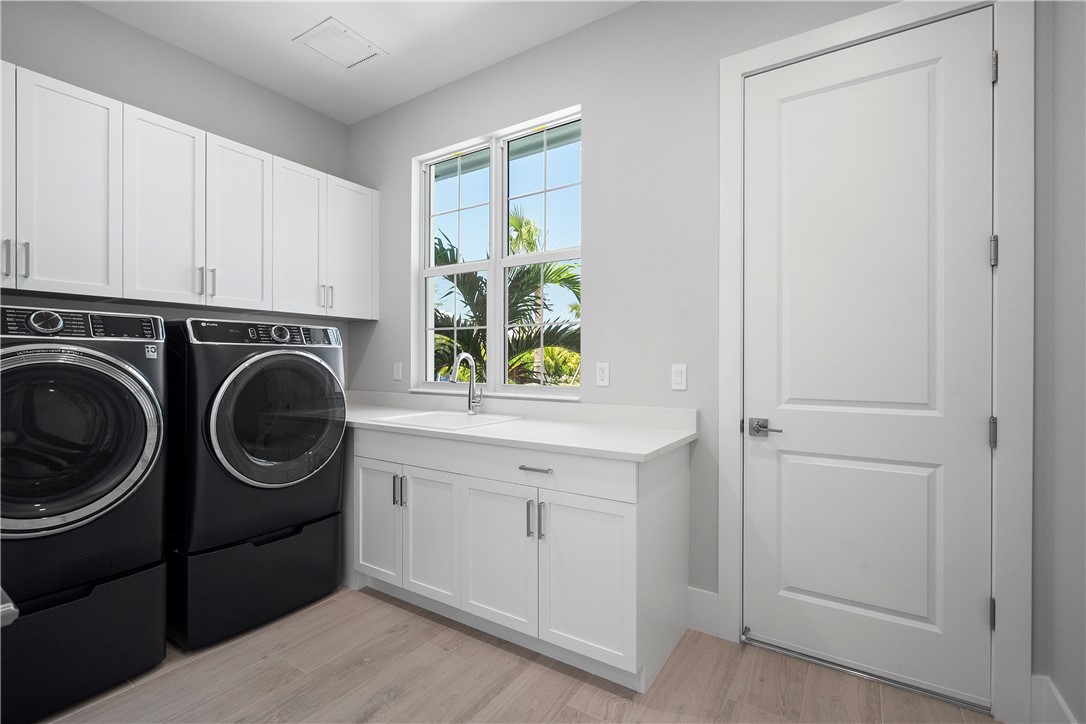 129 Strand Drive Vero Beach, FL 32963 - Photo 18 of 30 a utility room with sink dryer and washer