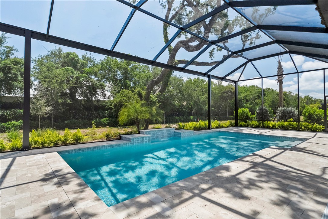 129 Strand Drive Vero Beach, FL 32963 - Photo 20 of 30 a view of a swimming pool with a yard