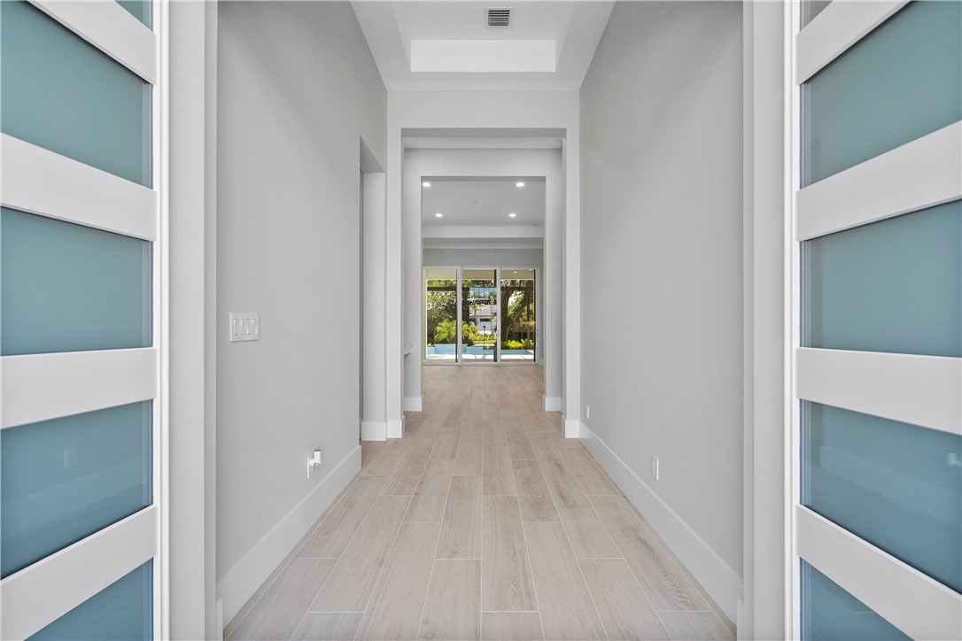 129 Strand Drive Vero Beach, FL 32963 - Photo 2 of 30 a view of a hallway with wooden floor