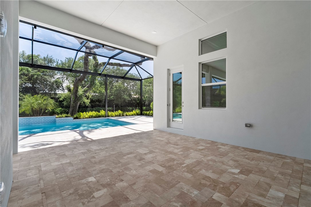 129 Strand Drive Vero Beach, FL 32963 - Photo 22 of 30 a view of an empty room with a floor to ceiling window and yard