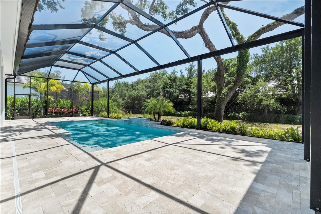 129 Strand Drive Vero Beach, FL 32963 - Photo 23 of 30 a view of a patio with a table and chairs under an umbrella