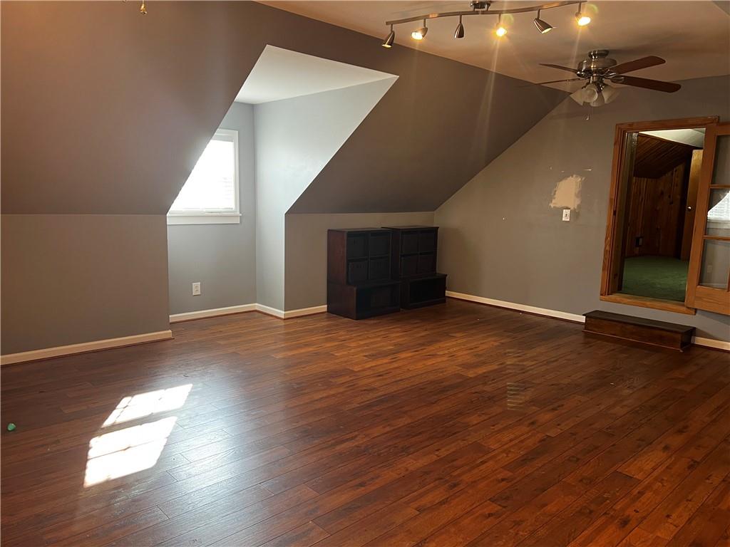 606 Pisgah Way Calhoun, GA 30701 - Photo 16 of 18 an empty room with wooden floor and windows