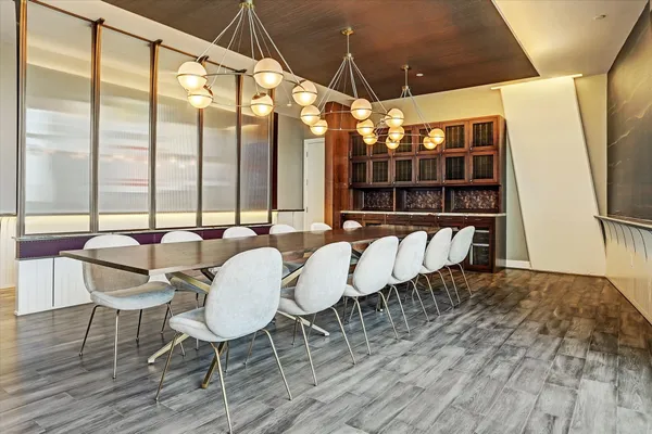 a dining room with furniture and a floor to ceiling window