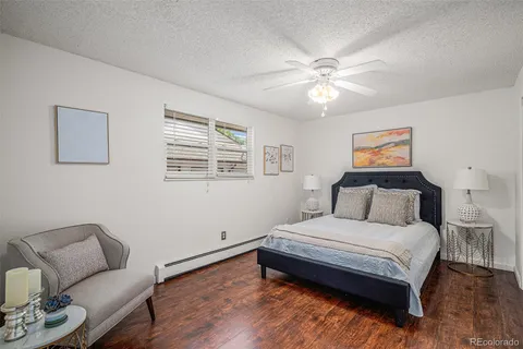 a bedroom with a bed couch and window