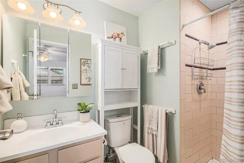 a bathroom with a sink toilet and shower