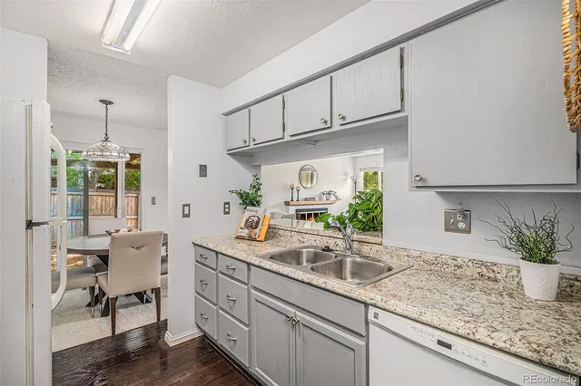 a kitchen with stainless steel appliances granite countertop a sink a stove and cabinets