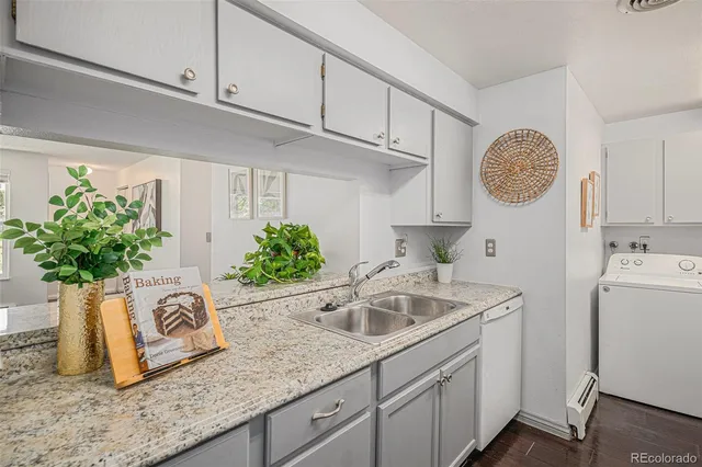 a view of sink with cabinets