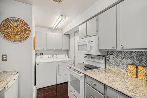 a kitchen with a sink a stove and cabinets
