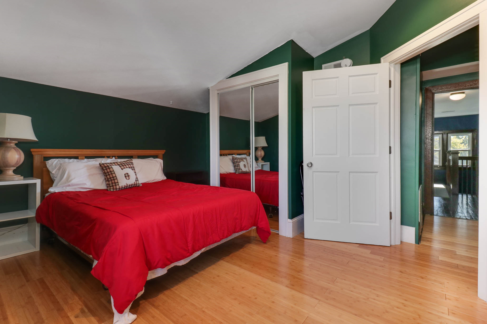 601 East Grove Street Bloomington, IL 61701 - Photo 27 of 42 a bedroom with a large bed and a wooden floor