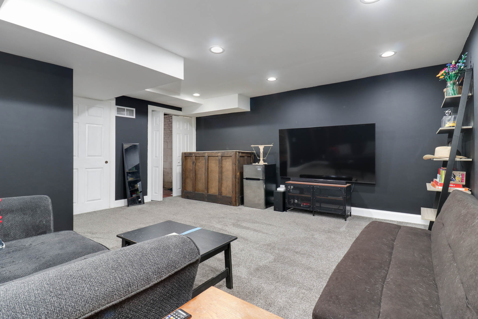 601 East Grove Street Bloomington, IL 61701 - Photo 33 of 42 a living room with furniture and a flat screen tv
