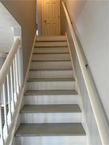 a view of empty room with window and wooden floor