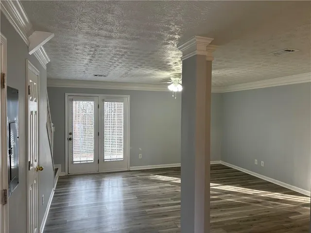 a view of a room with wooden floor and window