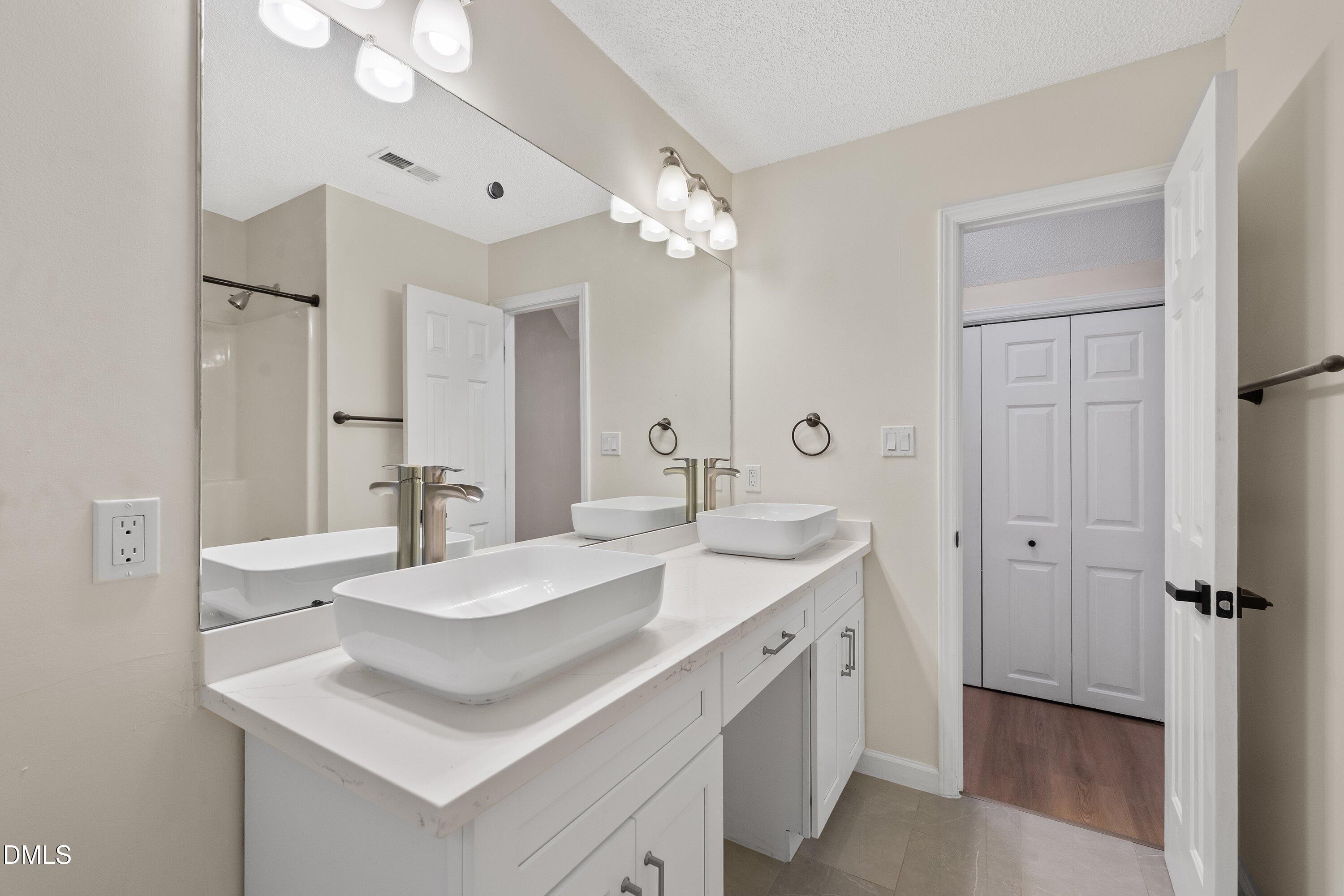 2517 Birchford Court Raleigh, NC 27604 - Photo 50 of 63 a bathroom with a sink double vanity and a mirror