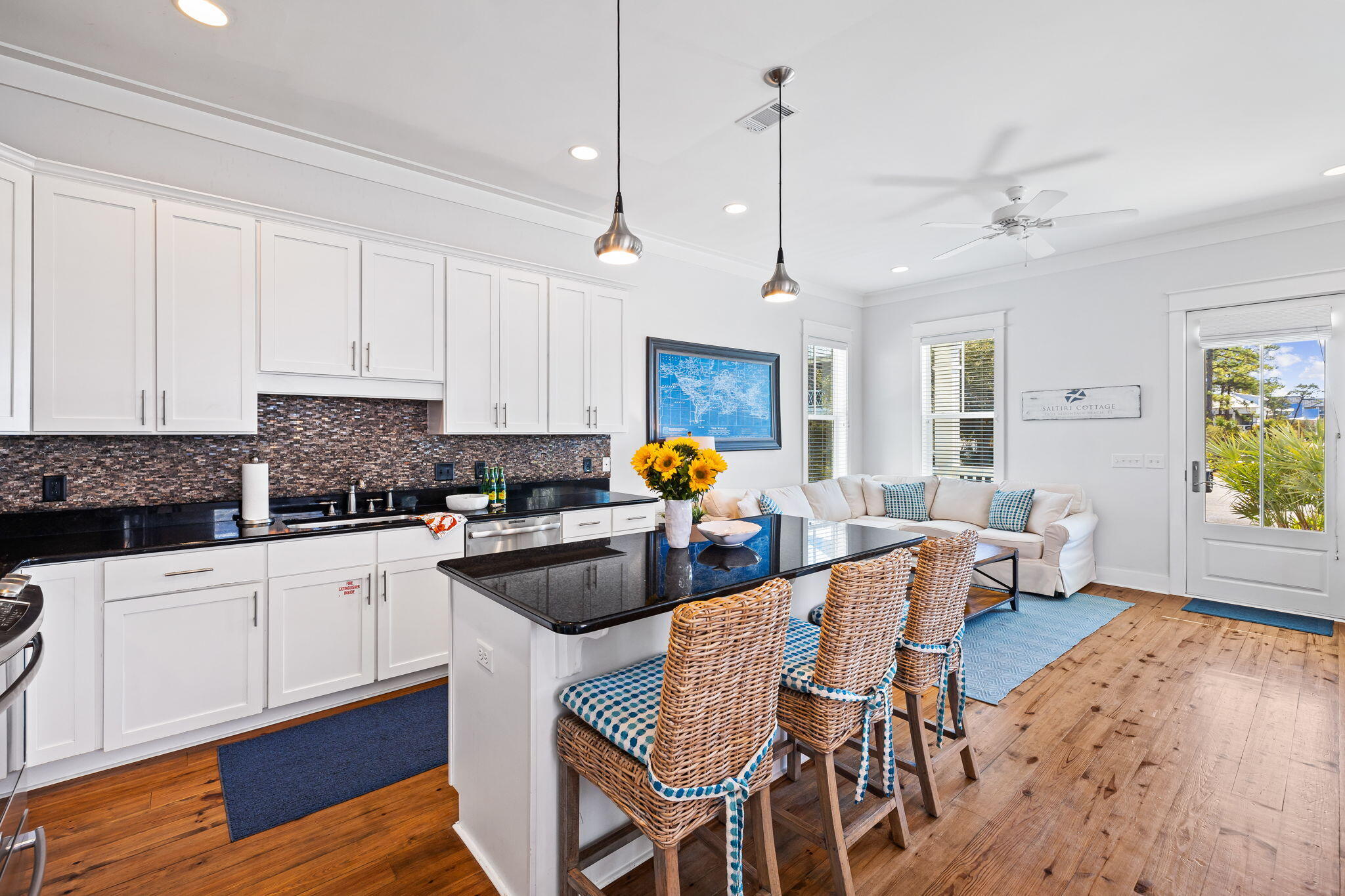 27 Matt's Way Santa Rosa Beach, FL 32459 - Photo 6 of 67 a kitchen with stainless steel appliances granite countertop a stove top oven a refrigerator a sink and white cabinets with wooden floor