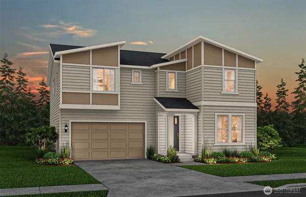 a front view of a house with a yard and garage