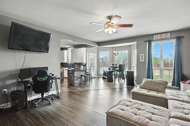a living room with furniture and a flat screen tv