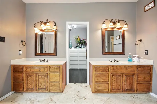 a bathroom with a double vanity sink mirror and