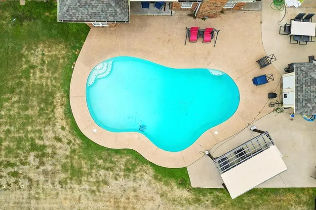 a view of a swimming pool with lounge chair