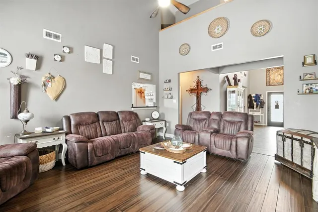 a living room with furniture and wooden floor
