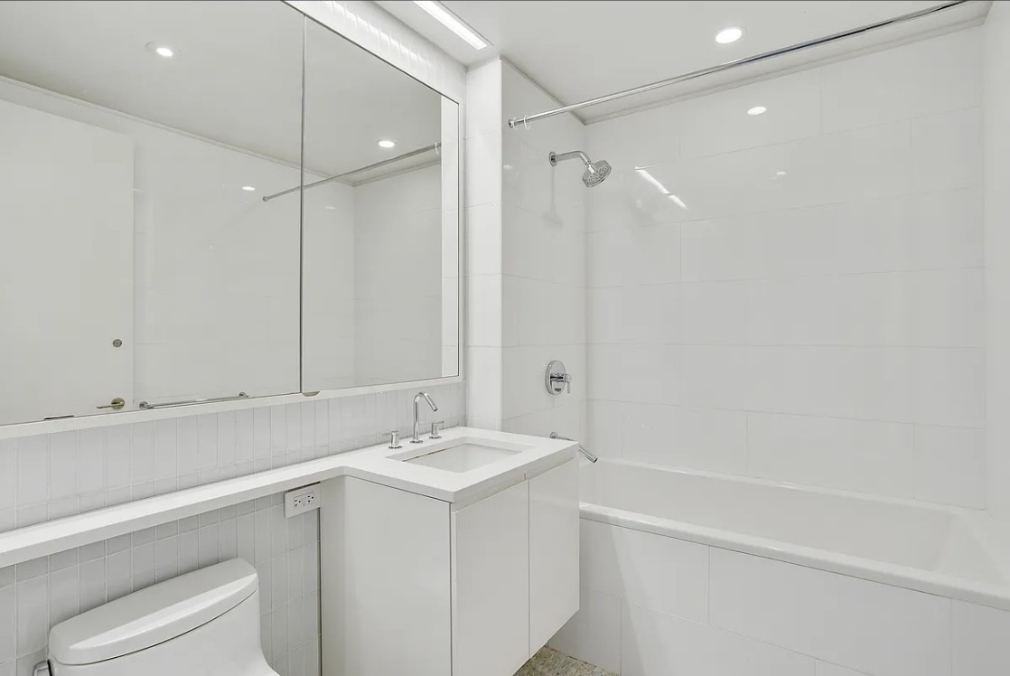 50 Riverside Boulevard, Unit 5B Manhattan, NY 10069 - Photo 8 of 26 a bathroom with a sink a toilet and a bathtub