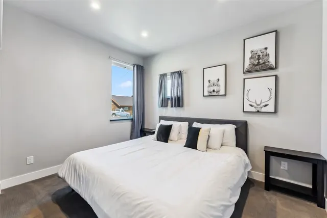 a bedroom with a bed and a painting