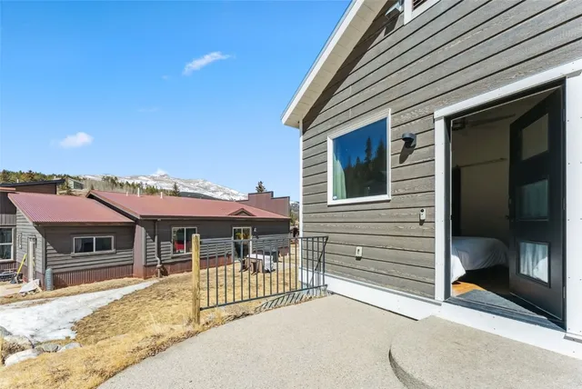 a view of a house with a yard and mountain